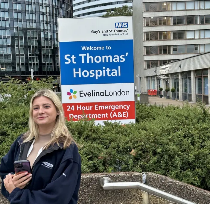 girl standing outside guys st thomas hospital in london