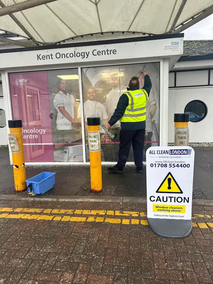 man cleaning windows on kent oncology centre in kent